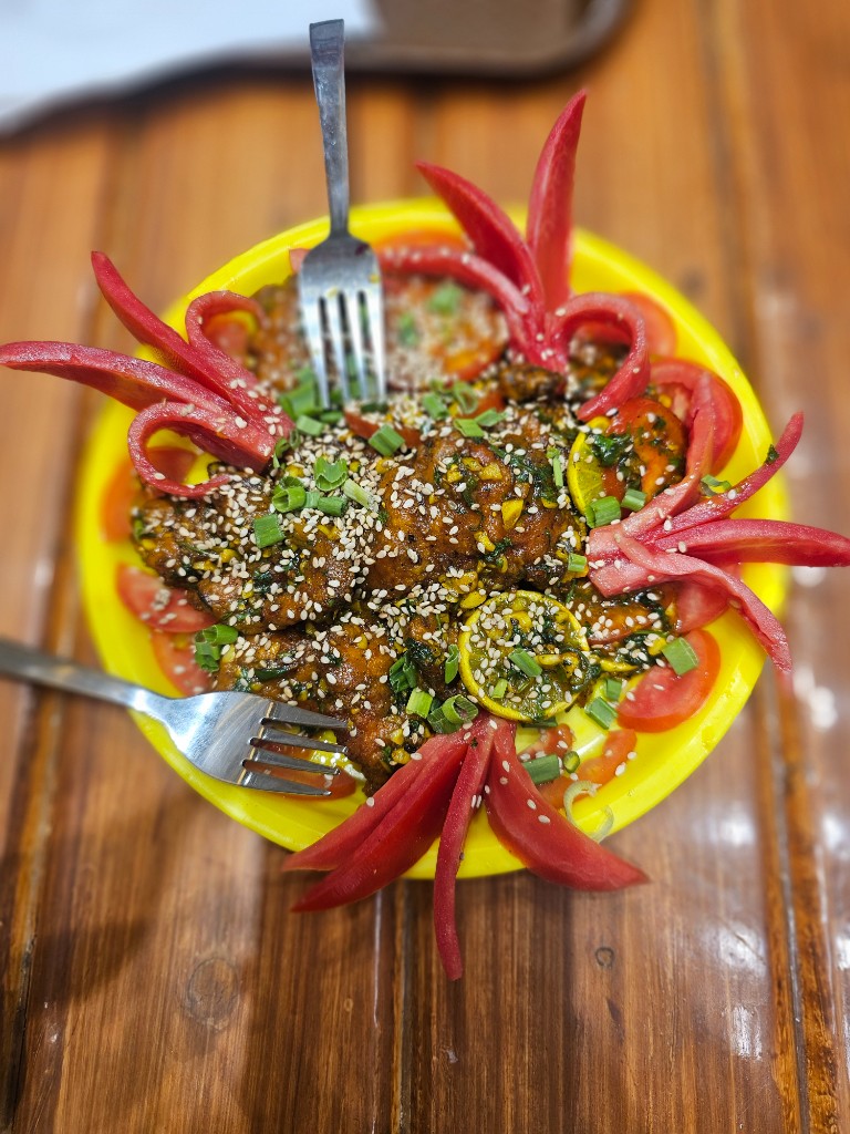 Signature sauced plate with sesame and garnish at The Street Brews