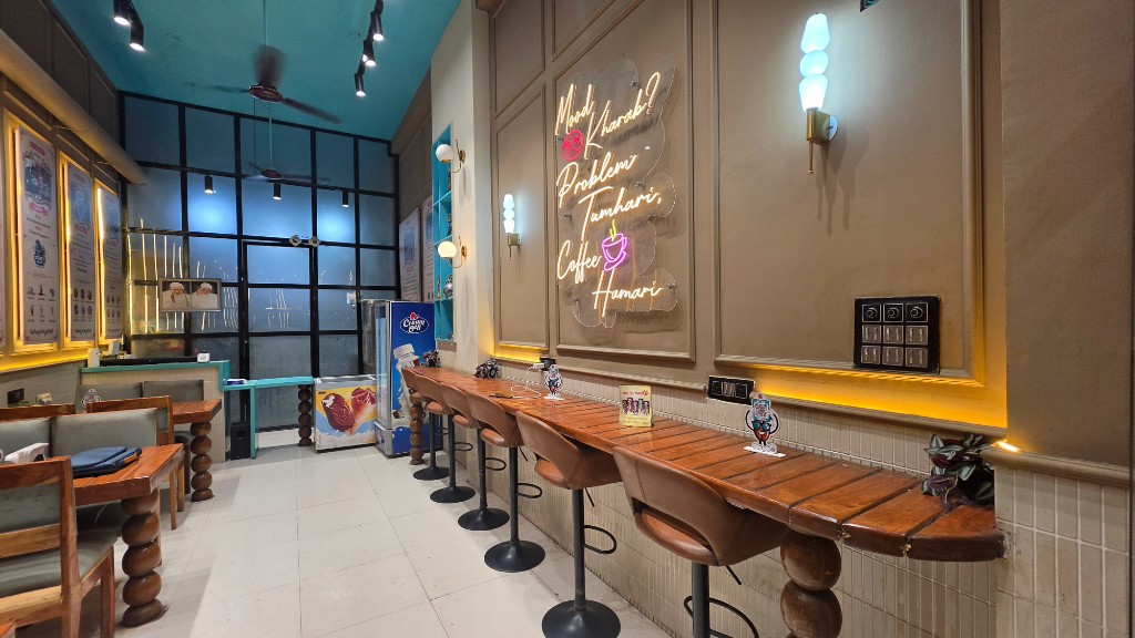 The Street Brews — bar seating and neon sign